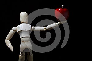 Wood robot and mini apple in action .
