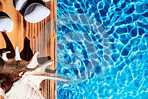 Wood sand board hot white salt stones and natural sea shell, conch. Water surface ocean. Massage therapy, copy space