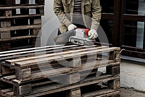 Wood sanding process by using handheld electric belt sander