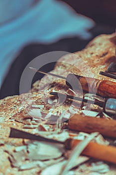 Wood sculptor tools on a table in workshop