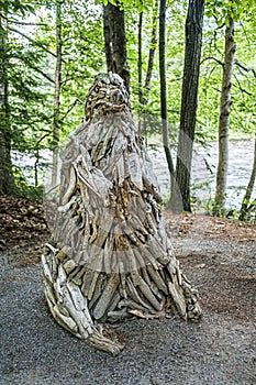 Wood sculpture  of a lstange figure in the Parc regional de la riviere du nord