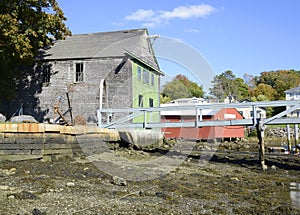 Wood shed by harbor in low tide