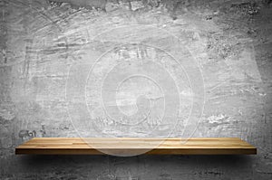 Wood shelf on bare concrete wall background