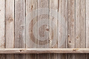 Wood shelf in front of wooden wall