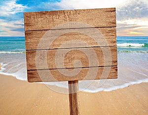 Wood sign on beach background