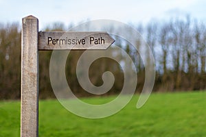 Wood sign marking the permissive path photo