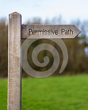 Wood sign marking the permissive path photo