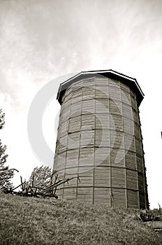 Wood silo with vintage plows adjacent