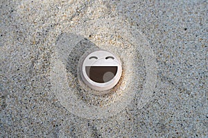 wood smile face on the sand. concept for Service rating, satisfaction concept