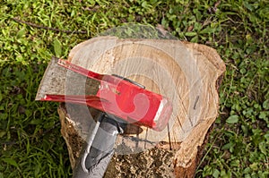 A wood splitting maul on top of a wooden log