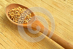 Wood spoon and roasted sesame seeds