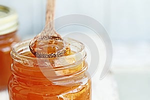 Wood Spoon of Cantaloupe Jam Resting on Jar