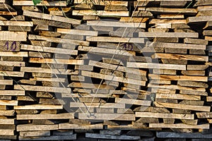 Wood stack of neatly stacked firewood and boards for drying fire