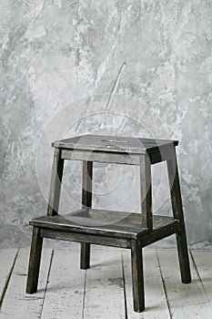 Wood stair-chair in modern loft room. grunge wall and wooden floor