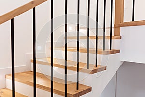 Wood staircase inside contemporary white modern house.