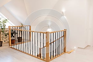 Wood staircase inside contemporary white modern house.