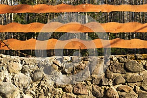 Wood and stone background. wooden fence and natural stone wall in the park