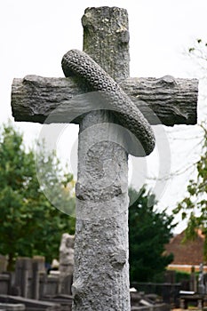 Wood stone cross on a grave. Historic graveyard.