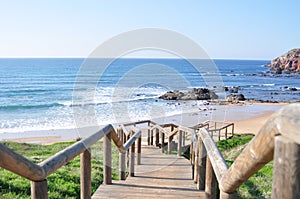 Wood stones beach way water ocean lake sunny day