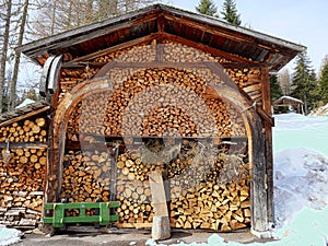Wood storage in italian Dolomites - lots of wooden beams