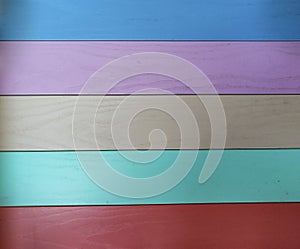 Wood Surface Fence Panel with boards painted Multicolored Paint, Close-up. Art Wooden Background. Wide Horizontal Image with Copy