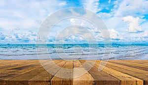 Wood table and blue sea and cloudy sky