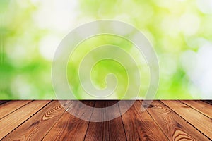 Wood table and bokeh abstract nature green background