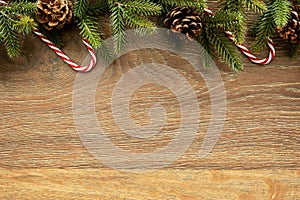 Wood table with Christmas decoration including pine branches and pine cones. Merry Christmas and happy new year concept. Top view