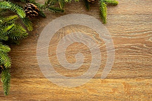 Wood table with Christmas decoration including pine branches and pine cones. Merry Christmas and happy new year concept. Top view