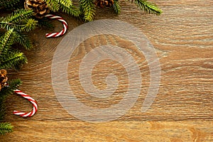 Wood table with Christmas decoration including pine branches and pine cones. Merry Christmas and happy new year concept. Top view