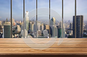 Wood table in city center modern office background