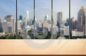 Wood table in city center modern office background