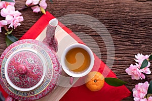 Wood table with cup of tea and Cherry blossom, Chinese new year celebration background