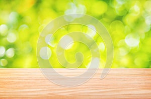 Wood table floor and beautiful natural green leaf abstract blurred bokeh light background