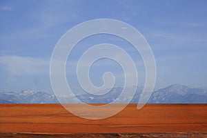 Wood table in front of blurred mountain view