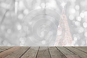 Wood table in front of white christmas bokeh lights