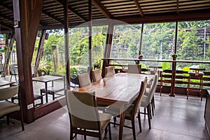 The wood table in the glass house ,decoration of room with wood