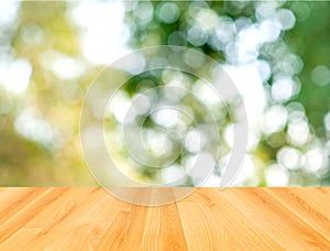 Wood table and green bokeh nature background