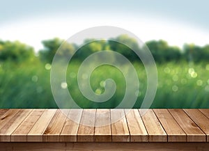 Wood table and green grass blurred background