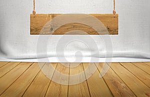 Wood table with hanging wooden sign on white fabric background