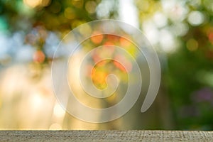 Wood table over blurred trees with bokeh background