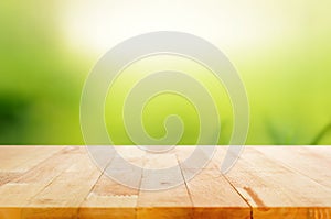 Wood table top on abstract nature green background