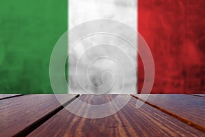 Wood Table Top Background with Italy national flag.