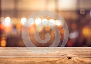 Wood table top Bar with blur colorful light bokeh in cafe,restaurant background photo