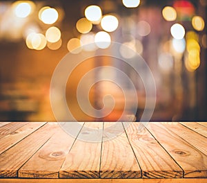 Wood table top Bar with blur light bokeh in dark night cafe,restaurant background