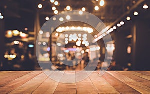 Wood table top Bar with blur light bokeh in dark night cafe photo