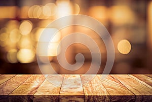 Wood table top Bar with blur light bokeh in dark night cafe,restaurant background