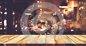 Wood table top Bar with blur night cafe background