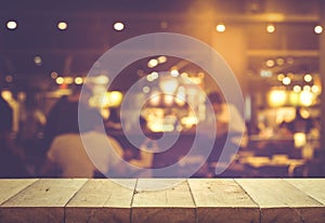 Wood table top (Bar) with blur people siting night cafe,restaurant background .Lifestyle and celebration concepts