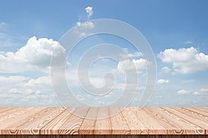 Wood table top on blue sky with clouds background